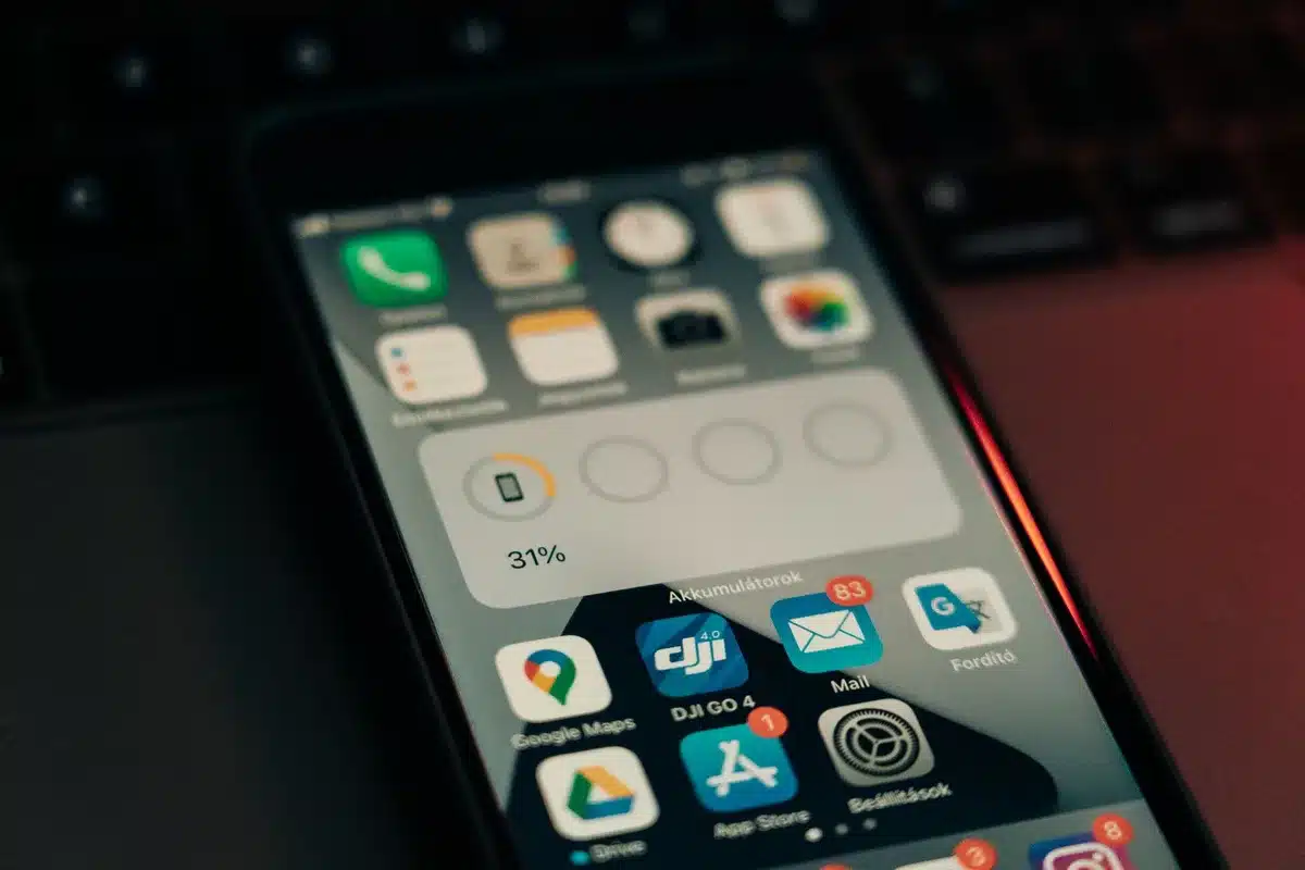 An anonymous smartphone on a desk showing a generic AI notification card beside a notepad and pen