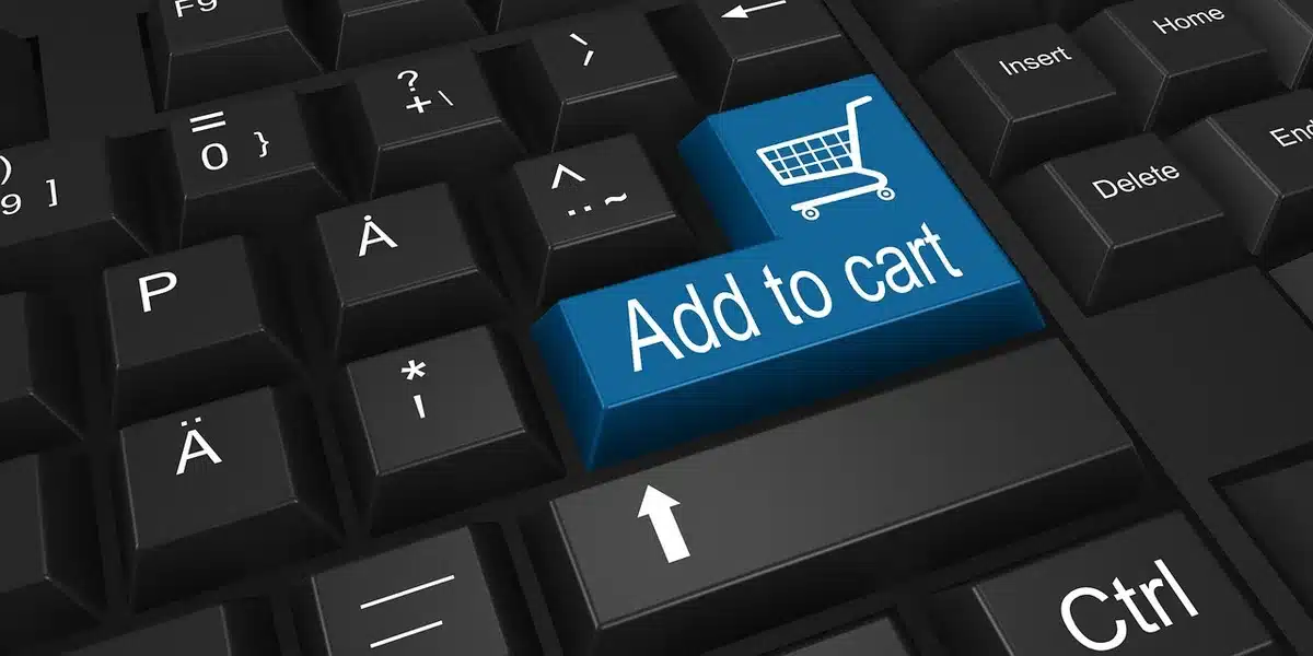 An anonymous person viewing a product listing on a laptop, hands visible on keyboard, the screen blurred to avoid identifiable logos or text